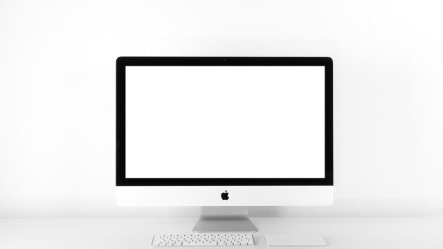 silver iMac with Apple Magic Keyboard on white sufrace
